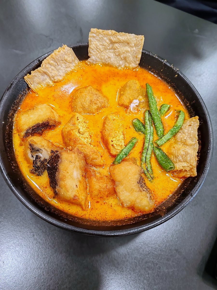 bowl of spicy curry fish noodle soup