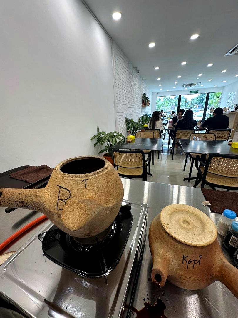 traditional clay beverage pots on counter with dining room background